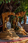 Vientiane, Laos - Pha That Luang, among the other structures on the ground there is a circular platform surrounding a large Bodhi tree contains Buddha images in several mudras.  